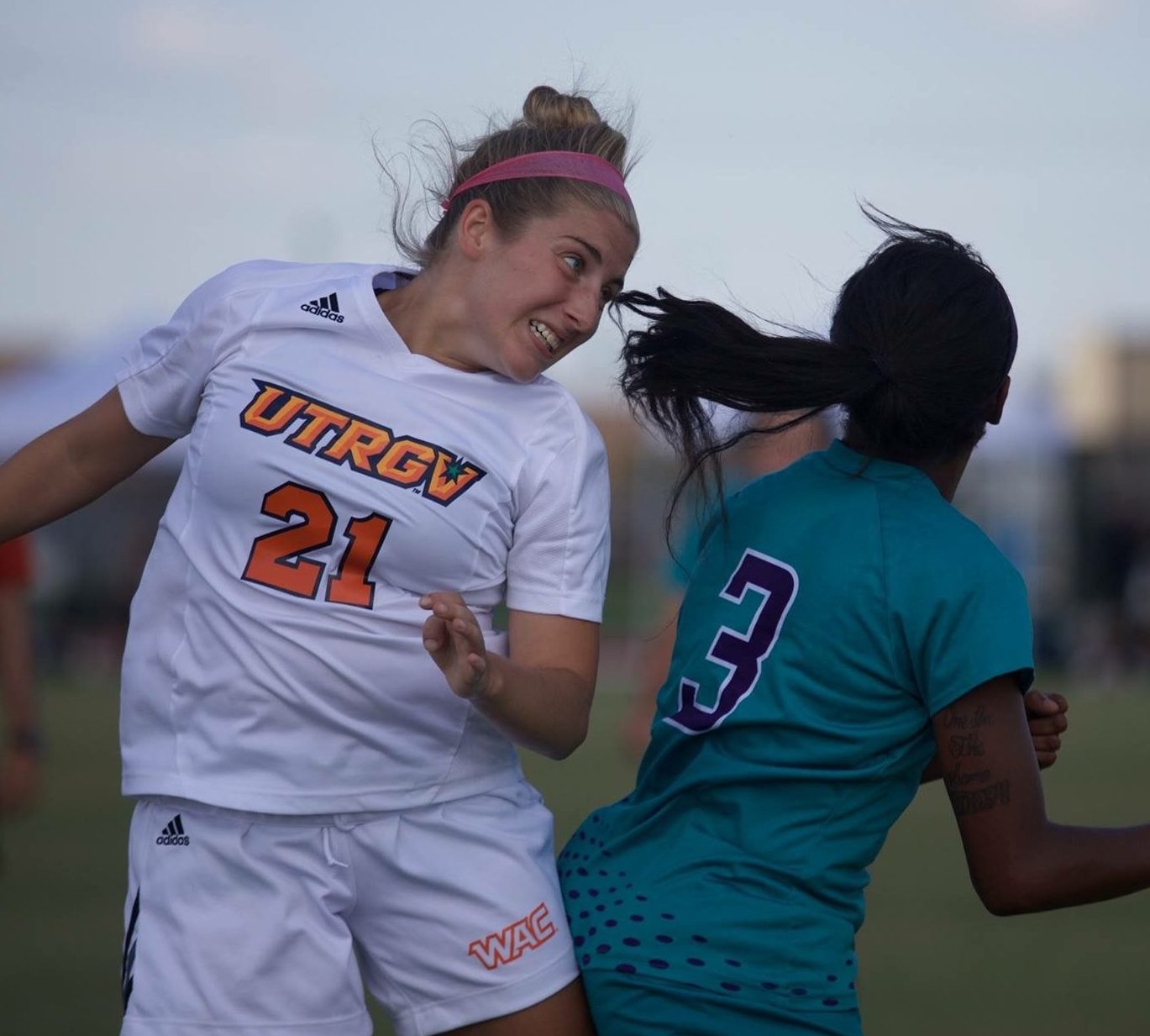 A soccer player from the University of Texas Rio Grande Valley jumping to head a ball